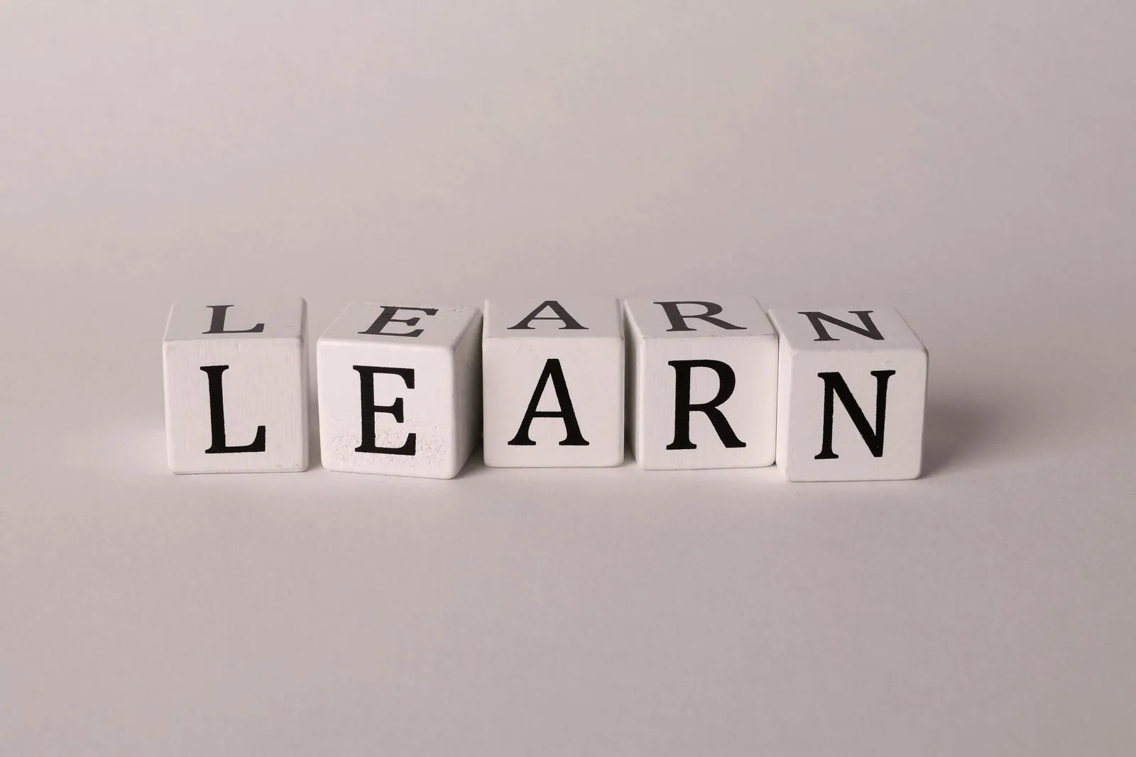 White letter blocks spelling LEARN, symbolizing the Russian learning journey