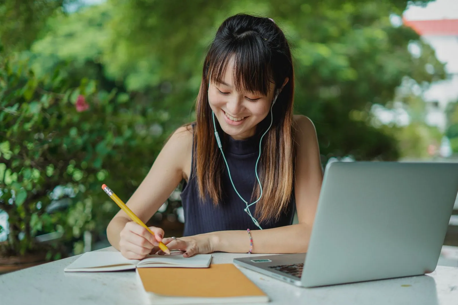 Student wearing headphones and listening while studying
