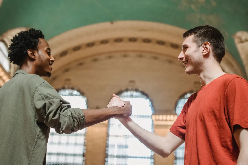 Two friends smiling and greeting each other